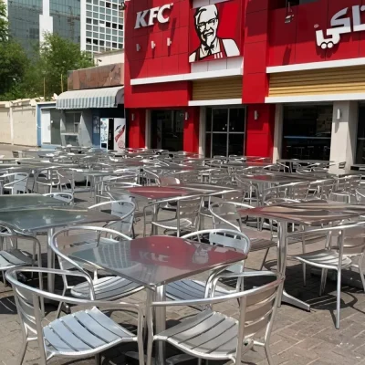 Exterior of a KFC with outdoor seating area of tables and chairs installed by Najmi Furniture