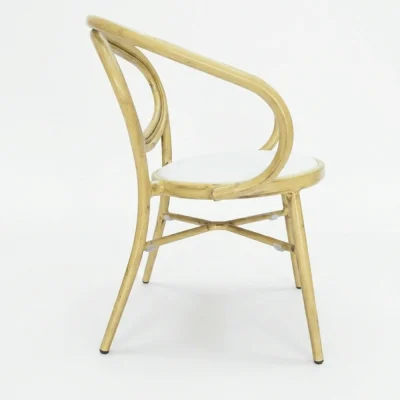outdoor cafe chair Light wood color chair with curved armrests and a white upholstered seat
